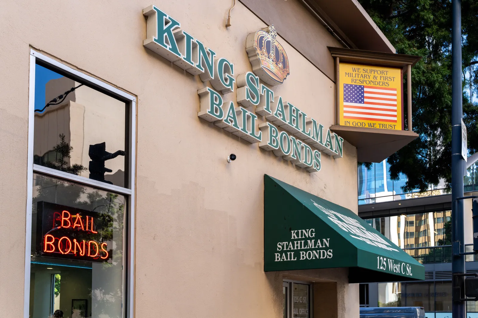 King Stahlman® Bail Bonds signage with the crown logo, neon 'Bail Bonds' window sign, and 'We Support Military & First Responders' flag at the downtown San Diego office
